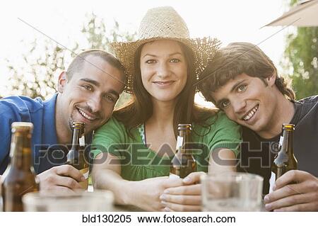 Friends drinking beer together outdoors View Large Photo Image Stock Photography - Friends drinking beer together outdoors. Fotosearch