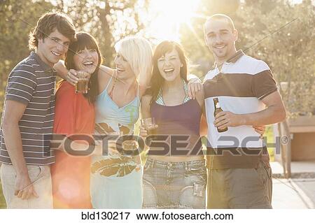 Friends drinking together at party View Large Photo Image Stock Photo - Friends drinking together at party. Fotosearch