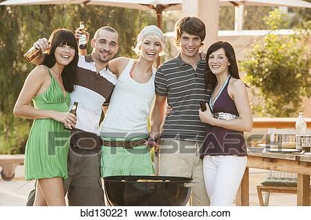 Friends having barbecue outdoors View Large Photo Image Stock Image - Friends having barbecue outdoors. Fotosearch