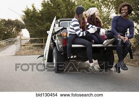 Friends having coffee together in truck bed View Large Photo Image Picture - Friends having coffee together in truck bed. Fotosearch