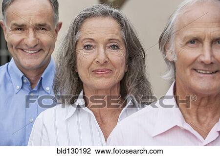 Stock Image - Friends smiling together outdoors. Fotosearch