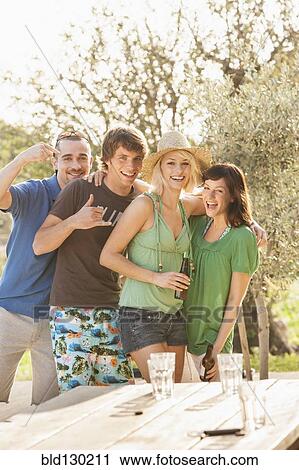 Friends smiling together outdoors View Large Photo Image Stock Image - Friends smiling together outdoors. Fotosearch