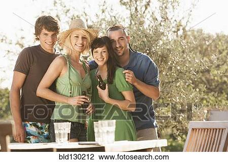 Stock Image - Friends smiling together outdoors. Fotosearch