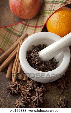 Stock Photo - Fruit with spices in pestle and mortar. Fotosearch