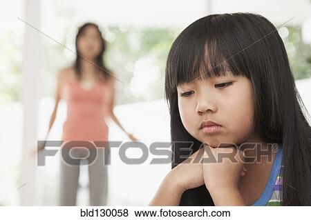 Stock Photo - Girl sitting with chin in hands. Fotosearch