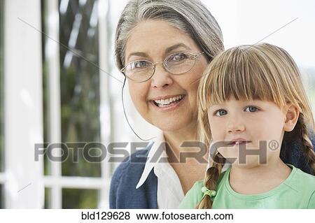 Stock Photo - Grandmother and granddaughter smiling. Fotosearch