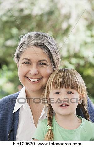 Grandmother and granddaughter smiling View Large Photo Image Stock Photo - Grandmother and granddaughter smiling. Fotosearch