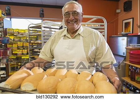 Hispanic baker working in commercial kitchen View Large Photo Image Stock Image - Hispanic baker working in commercial kitchen. Fotosearch