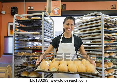 Hispanic baker working in commercial kitchen View Large Photo Image Stock Image - Hispanic baker working in commercial kitchen. Fotosearch