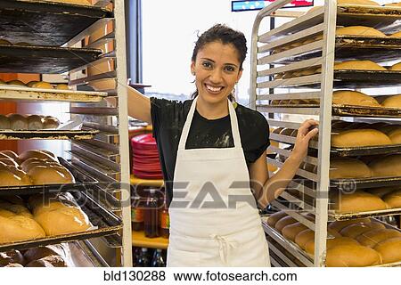 Hispanic baker working in commercial kitchen View Large Photo Image Stock Photo - Hispanic baker working in commercial kitchen. Fotosearch