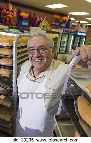 Hispanic baker working in commercial kitchen View Large Photo Image Stock Photography - Hispanic baker working in commercial kitchen. Fotosearch