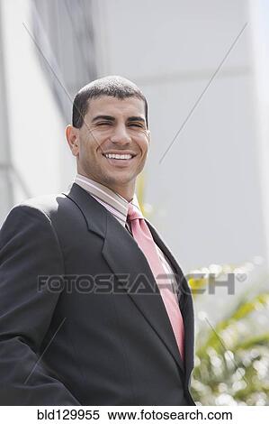 Stock Photography - Hispanic businessman smiling. Fotosearch