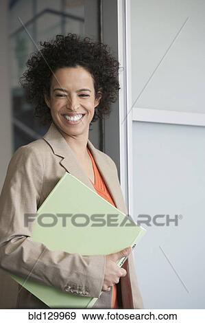 Hispanic businesswoman smiling in doorway View Large Photo Image Stock Photo - Hispanic businesswoman smiling in doorway. Fotosearch