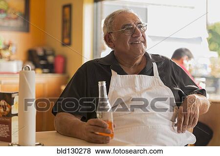 Hispanic chef drinking soda in cafe View Large Photo Image Stock Photo - Hispanic chef drinking soda in cafe. Fotosearch