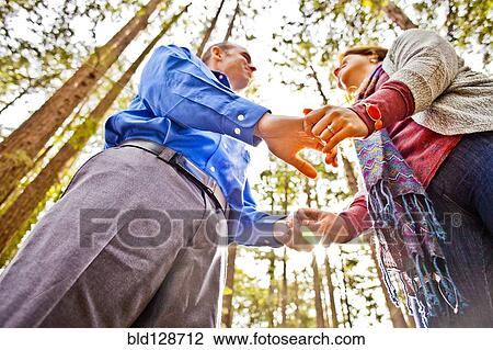 Hispanic couple holding hands in forest View Large Photo Image Stock Image - Hispanic couple holding hands in forest. Fotosearch