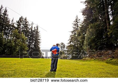 Stock Photo - Hispanic couple hugging in park. Fotosearch