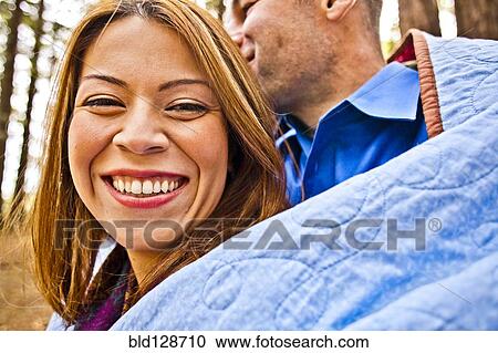 Hispanic couple wrapped in blanket in forest View Large Photo Image Stock Image - Hispanic couple wrapped in blanket in forest. Fotosearch