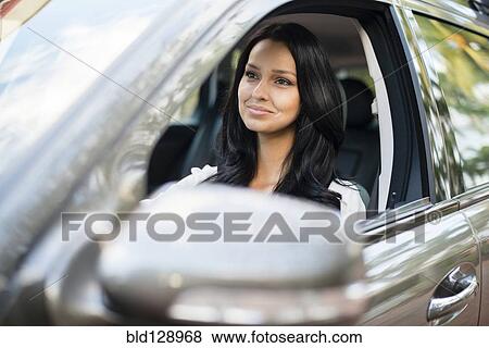 Hispanic woman driving car View Large Photo Image Stock Photo - Hispanic woman driving car. Fotosearch