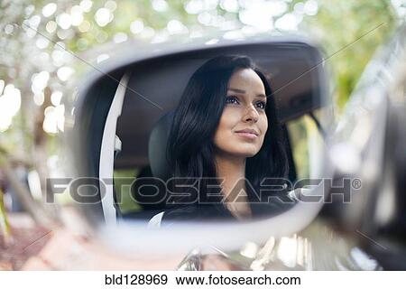 Hispanic woman driving car View Large Photo Image Stock Photo - Hispanic woman driving car. Fotosearch