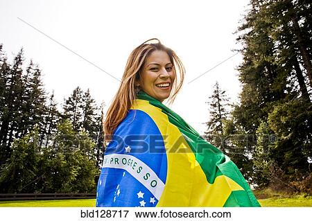 Hispanic woman wrapped in Brazilian flag View Large Photo Image Stock Photo - Hispanic woman wrapped in Brazilian flag. Fotosearch