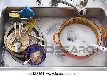Stock Image - Kitchen sink full of dirty dishes. Fotosearch