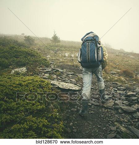 Mari man hiking on rocky hillside View Large Photo Image Stock Image - Mari man hiking on rocky hillside. Fotosearch