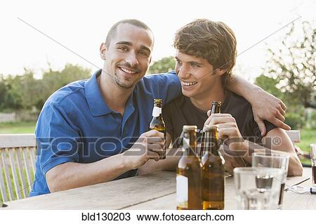 Men drinking beer together outdoors View Large Photo Image Stock Image - Men drinking beer together outdoors. Fotosearch