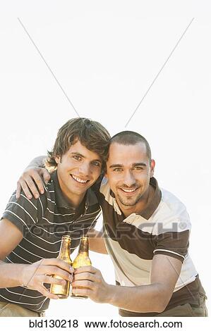 Stock Photo - Men drinking beer together outdoors. Fotosearch