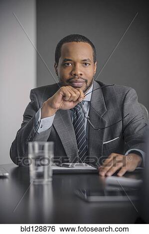 Mixed race businessman sitting in meeting View Large Photo Image Stock Photograph - Mixed race businessman sitting in meeting. Fotosearch