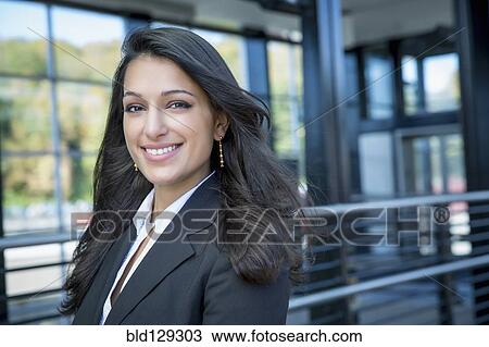 Mixed race businesswoman smiling outdoors View Large Photo Image Stock Image - Mixed race businesswoman smiling outdoors. Fotosearch