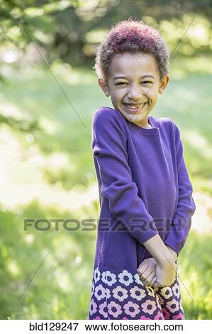 Mixed race girl smiling outdoors View Large Photo Image Stock Photo - Mixed race girl smiling outdoors. Fotosearch