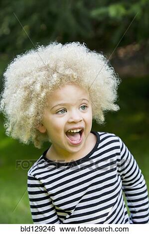 Stock Photograph - Mixed race girl smiling outdoors. Fotosearch