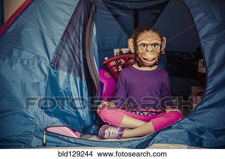 Mixed race girl wearing mask in tent View Large Photo Image Picture - Mixed race girl wearing mask in tent. Fotosearch