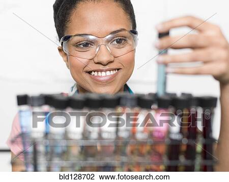 Mixed race student examining samples in lab View Large Photo Image Stock Image - Mixed race student examining samples in lab. Fotosearch