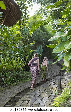 Picture - Mother and children walking along stone path. Fotosearch