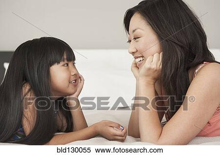 Mother and daughter talking on bed View Large Photo Image Stock Photography - Mother and daughter talking on bed. Fotosearch