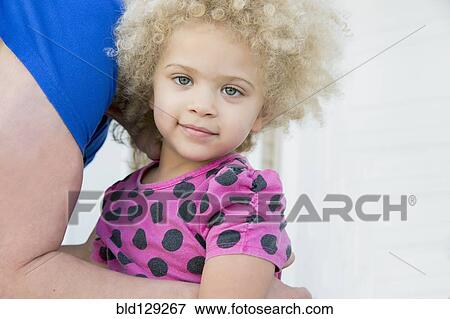 Stock Photo - Mother picking up daughter outdoors. Fotosearch