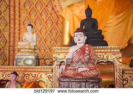 Ornate Buddha statues in temple View Large Photo Image Stock Photo - Ornate Buddha statues in temple. Fotosearch