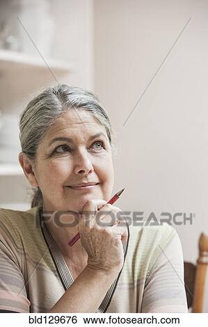 Stock Photograph - Pensive Caucasian woman. Fotosearch