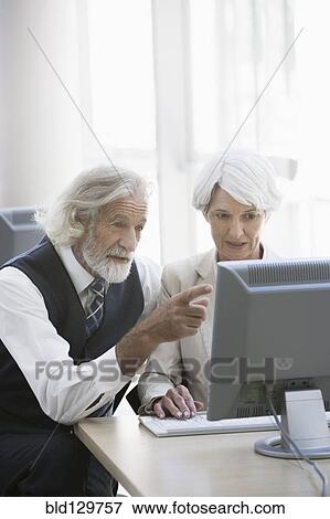 Stock Photo - Senior Caucasian business people working together in office. Fotosearch