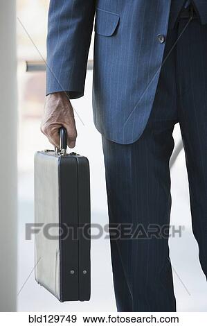 Stock Photo - Senior Caucasian businessman carrying briefcase. Fotosearch