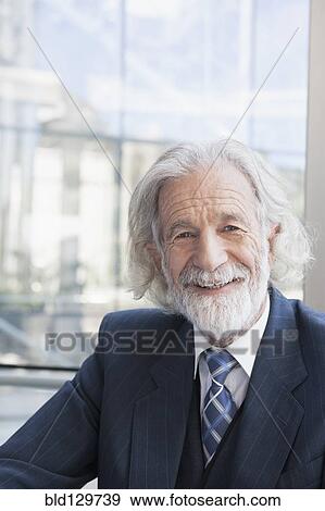 Stock Photo - Senior Caucasian businessman smiling in office. Fotosearch