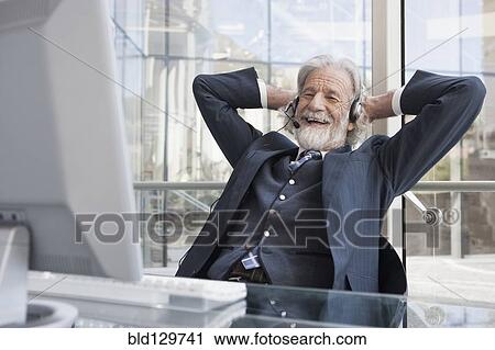 Senior Caucasian businessman talking on headset View Large Photo Image Stock Image - Senior Caucasian businessman talking on headset. Fotosearch