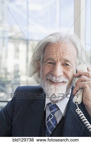 Senior Caucasian businessman talking on phone View Large Photo Image Stock Photo - Senior Caucasian businessman talking on phone. Fotosearch