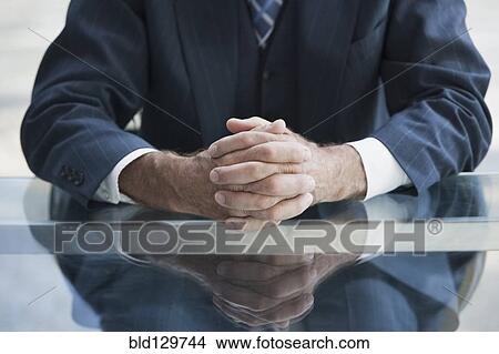 Picture - Senior Caucasian businessman's folded hands. Fotosearch