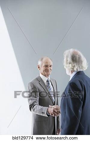 Picture - Senior Caucasian businessmen shaking hands. Fotosearch