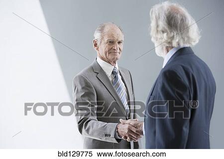 Senior Caucasian businessmen shaking hands View Large Photo Image Stock Photography - Senior Caucasian businessmen shaking hands. Fotosearch