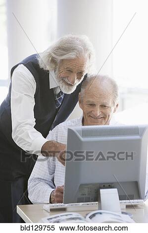 Senior Caucasian businessmen working together in office View Large Photo Image Stock Photography - Senior Caucasian businessmen working together in office. Fotosearch