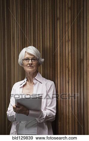 Stock Photo - Senior Caucasian businesswoman taking notes. Fotosearch
