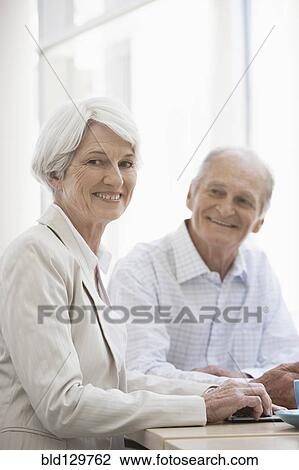 Stock Image - Senior Caucasian couple having coffee in cafe. Fotosearch